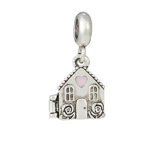 Detailed view of silver house charm with pink heart window and floral relief