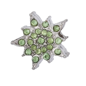 Detailed close-up of snowflake pendant with green crystals and silver metal setting