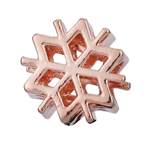 Macro shot of rose gold snowflake charm with geometric hollow design for DIY jewelry