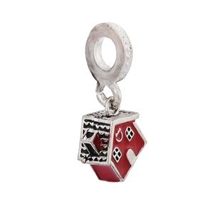 Macro shot of silver house charm with red enamel details and a large hanging ring