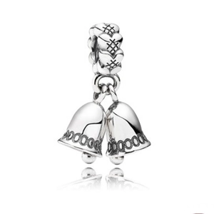 Silver bracelet charm featuring double bells and heart pattern connector on white background