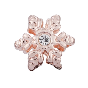 Macro shot of rose gold snowflake charm with center cubic zirconia for jewelry making