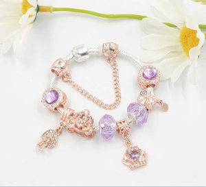 Rose gold snake chain charm bracelet with purple gemstone beads and crown pendant
