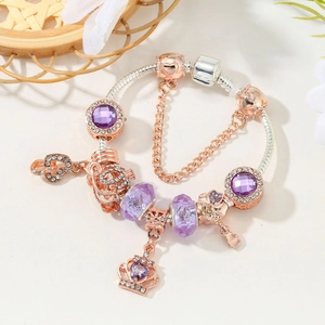 Silver and rose gold snake chain bracelet with purple crystal beads and crown pendant