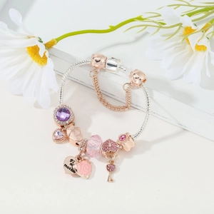 Detail of rose gold charm bracelet with For Mother heart tag and purple crystal beads