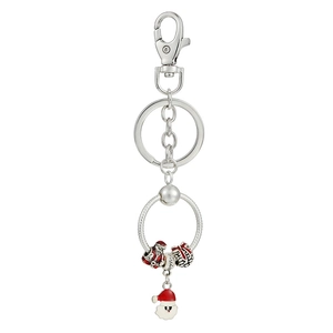 Detail view of silver keychain featuring Santa Claus charms and red enamel gift box pendant