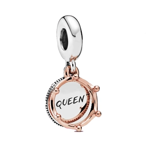 Macro detail of silver charm pendant with rose gold crown and QUEEN inscription