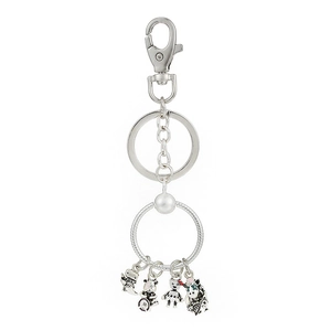 Detail of silver keychain with cartoon dinosaur bear and robot charms in enamel finish