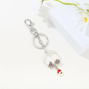 Detail of Christmas beaded keychain with Santa pendant and red enamel beads on silver ring