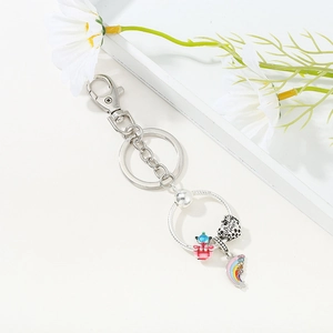 DIY silver metal keychain with pink castle charm and Bee Happy heart pendant