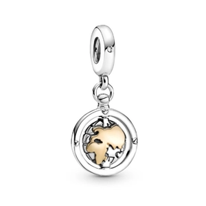 Detailed macro view of two-tone spinning globe charm with silver frame and gold land accents
