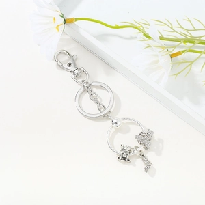 Silver keychain featuring princess crown, sparkling high heel charms, and metal lobster clasp