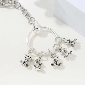 Detailed macro of silver metal keychain with five vintage cartoon animal charms
