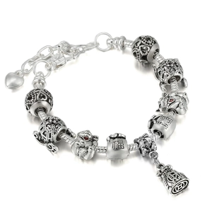 Detailed macro shot of silver lucky charm beads with S925 engraving on snake chain