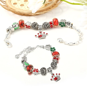 Detail of silver beaded bracelets with festive charms and heart-shaped extension chain