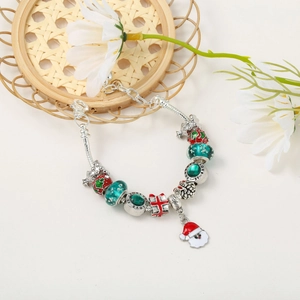 Detail of Christmas charm bracelet with Santa, gift box pendants and glowing glass beads
