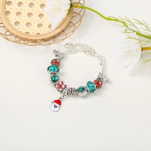 Detail of Christmas beaded bracelet with red enamel charms and Santa Claus pendant