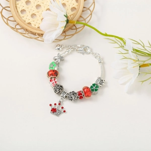 Detail of Christmas beaded bracelet with red enamel hearts and a crown charm