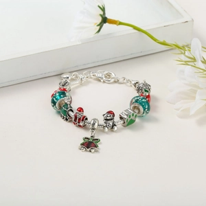 Close-up of Christmas charm bracelet with red and green beads and Santa Claus pendant