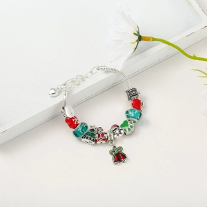 Detail of silver snake chain bracelet with enamel Christmas tree and Santa Claus charms