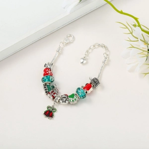 Detail of Christmas charm bracelet with Santa, bells, and Merry tree charms