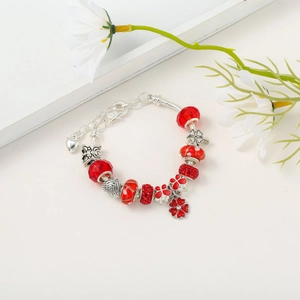 Detailed close-up of S925 sterling silver Christmas charm bracelet with red beads