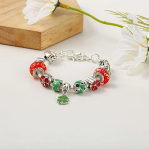 Detailed view of snake chain bracelet featuring green clover charm and enamel beads