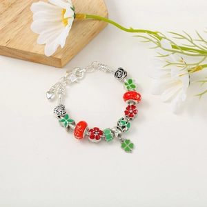 Luminous Christmas charm bracelet with red and green enamel beads and clover pendant
