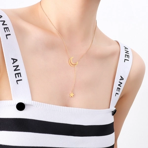 Elegant 18K gold star and moon pendant necklace worn by a model on a white background