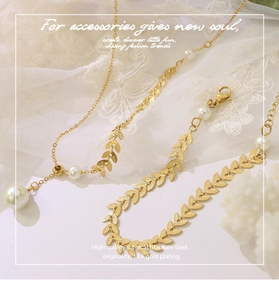 Close-up of 18k gold plated surgical titanium steel leaf link chain with white pearls