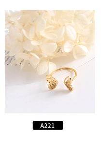 Detailed view of an 18k gold butterfly open ring with hollow wings on white surface