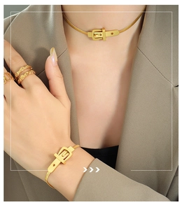 Detail of gold belt buckle style snake chain necklace and bracelet jewelry set