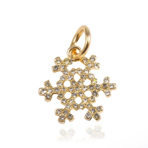 Macro shot of gold-plated snowflake pendant with white pavé crystals for DIY bracelets