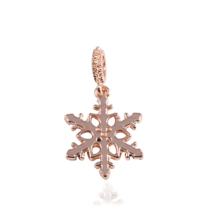 Macro detail of rose gold snowflake charm with pavé setting and geometric cutouts