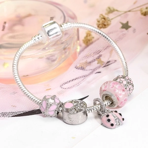 Pink floral bead bracelet with sparkling ladybug charm on silver snake chain