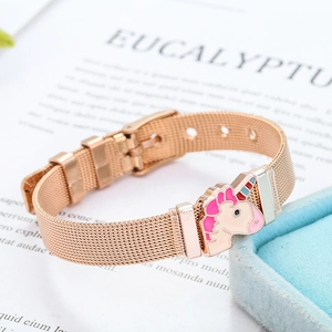 Detail of rose gold mesh bracelet with a pink enamel unicorn charm on a white background