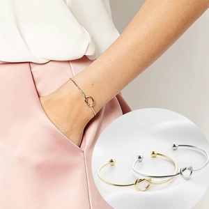 Minimalist knotted open bangle in gold and silver finish with ball ends for women