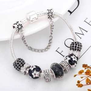 Elegant silver snake chain charm bracelet with black enamel flowers and sparkling rhinestones