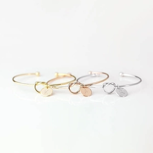 Minimalist knotted cuff bracelet set with personalized letter charms in three metallic colors