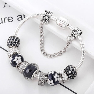 Elegant silver snake chain bracelet with black enamel flowers and pave zircon charms