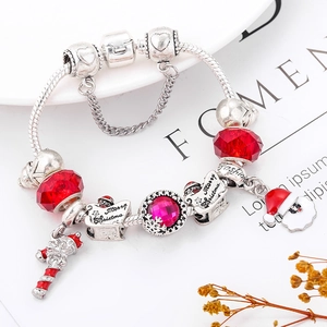 Detail of Christmas charm bracelet with red glass beads and Merry Christmas pendants