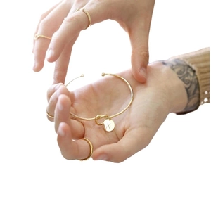 Minimalist knot cuff bracelet with K letter charm pendant and gold stacking rings set