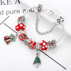 Macro shot of Christmas bracelet with red glass beads and holiday charms on silver chain