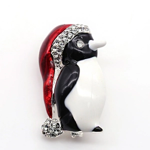 Detailed view of Christmas penguin brooch with red enamel hat and sparkling rhinestones