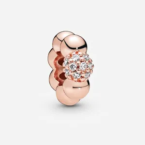 Macro shot of rose gold charm bead featuring a central cluster of white cubic zirconia