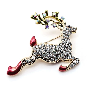 Close-up of golden Christmas deer brooch with white crystals and colorful rhinestone antlers