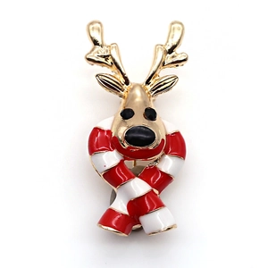 Detail of a Christmas reindeer brooch with gold antlers and red striped scarf on white background