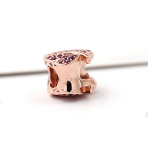 Macro detail of rose gold charm bead featuring purple pavé crystals for DIY bracelets
