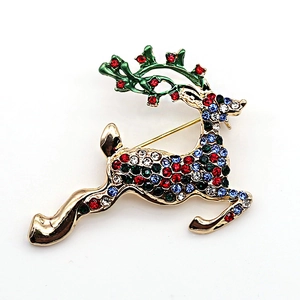 Vintage Christmas reindeer brooch with colorful rhinestones and green enamel on gold metal