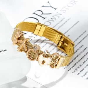 Golden 10mm stainless steel mesh bracelet with airplane, heart and ring charms